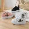 Three pairs of children's casual shoes in pink, white and black details Picture